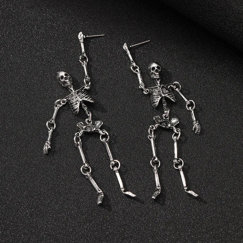 Exaggerated zinc alloy skull earrings in antique silver with line-patterned detailing, unisex design