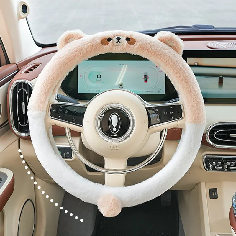 Plush furry steering wheel cover with embroidered panda face, fitted on a car steering wheel.