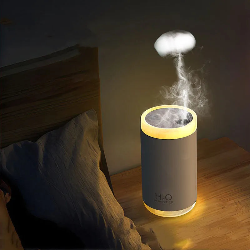 White jellyfish humidifier emitting smoke ring mist with warm night light on a desk