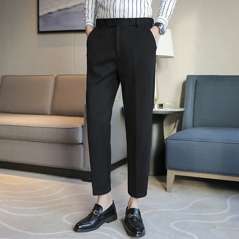 Straight-leg brown corduroy trousers with an elastic waistband laid flat.