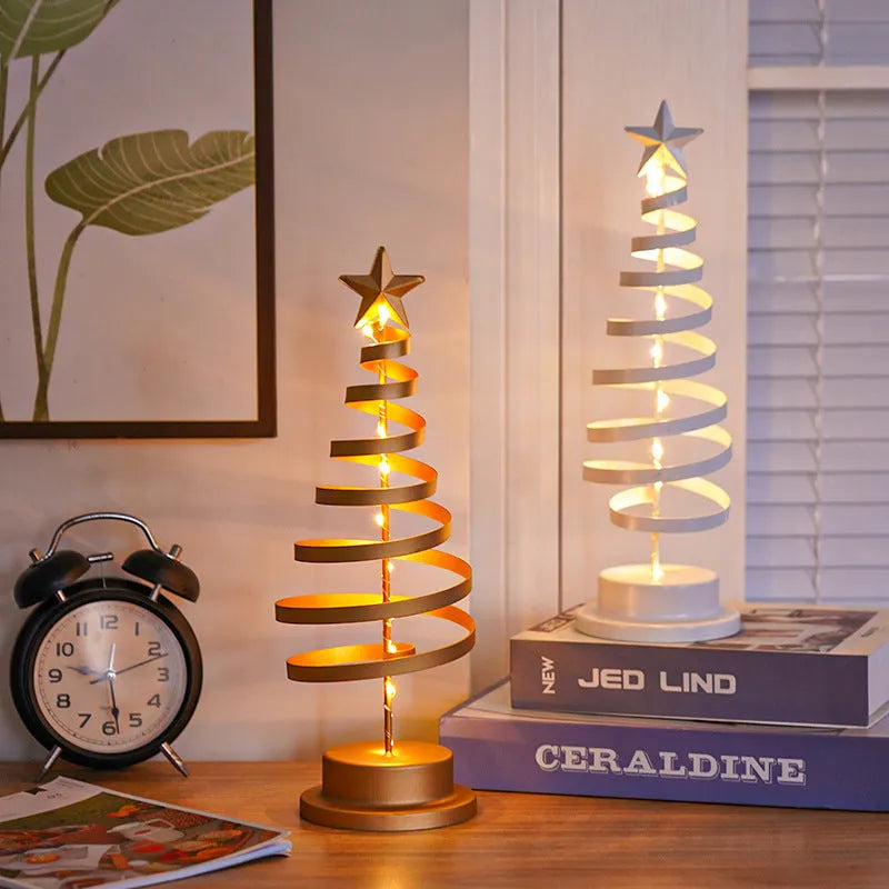 Wrought iron LED Christmas tree spiral light on a table, glowing warm white.
