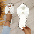 Women's black and white leopard print beach slippers with a thick sole and round toe.