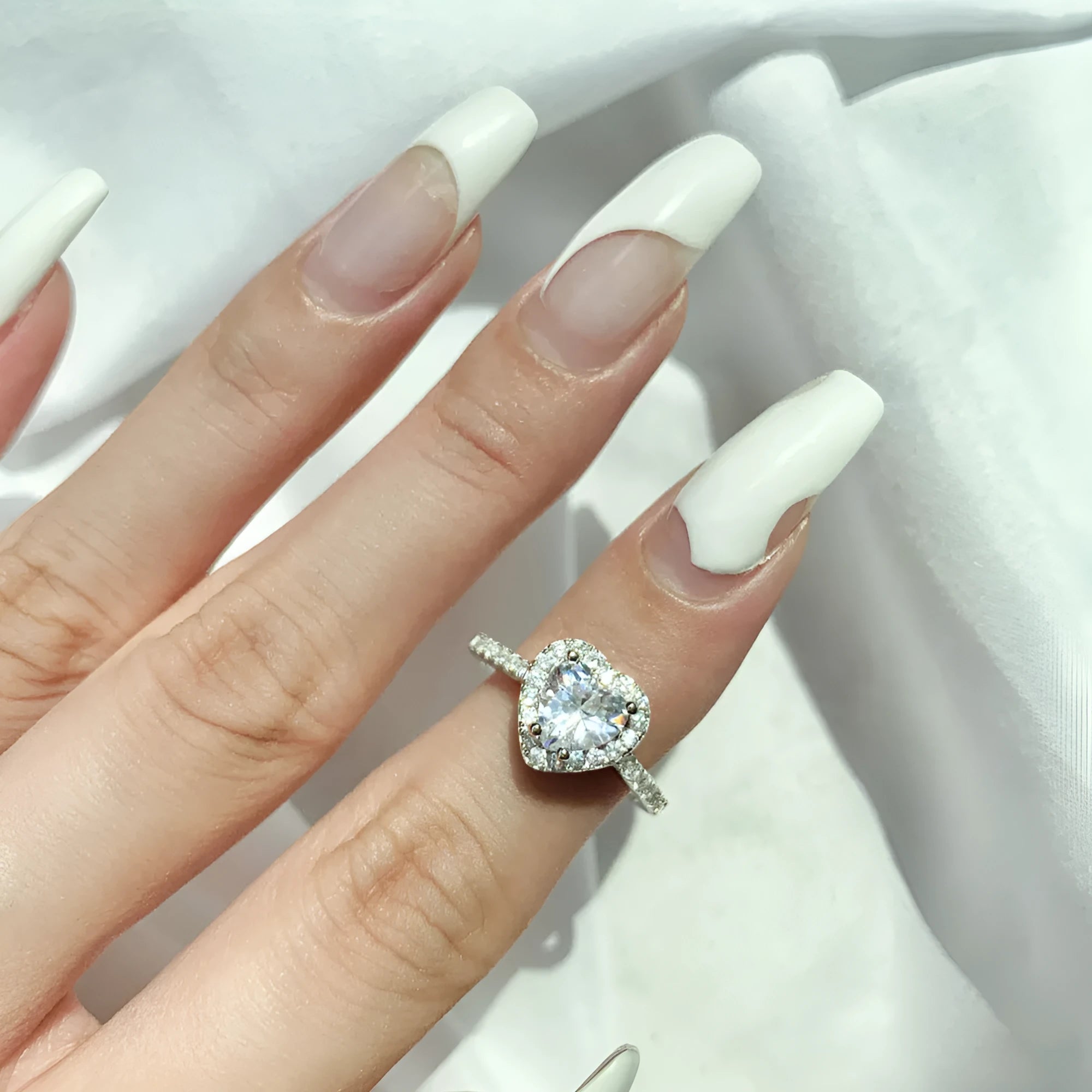 Women's S925 sterling silver heart-shaped ring in white diamond electroplated finish on white background