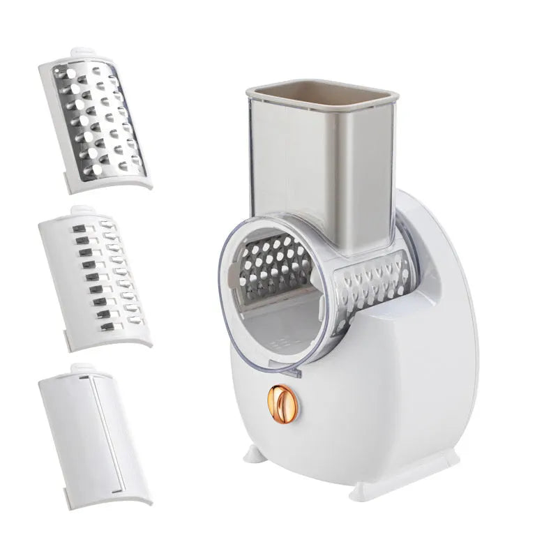 White electric vegetable slicer with rotary grater, blade barrel, and suction base on a kitchen counter.