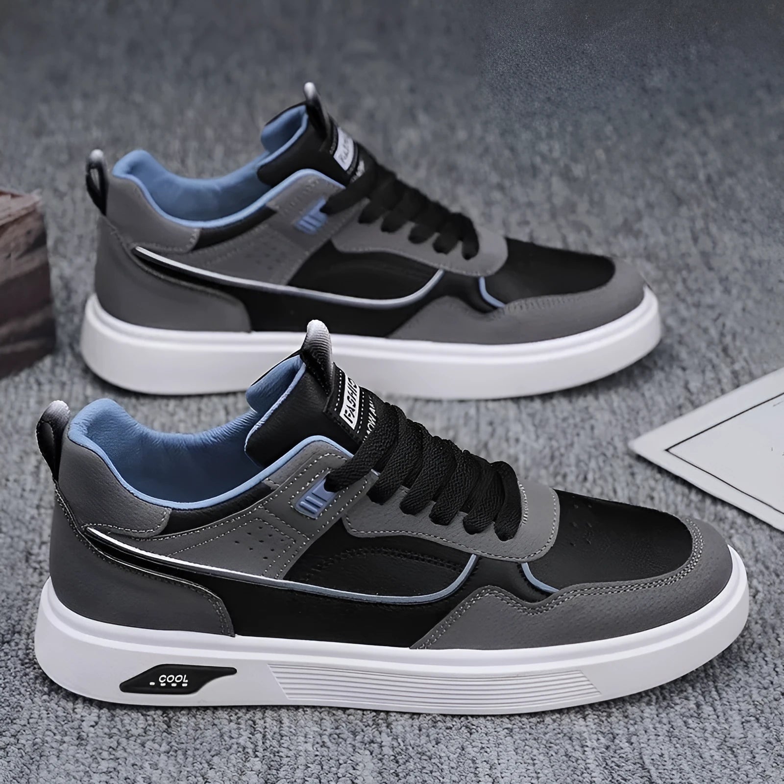 Men's beige low-top canvas board shoes with leather stitching details on a white background.