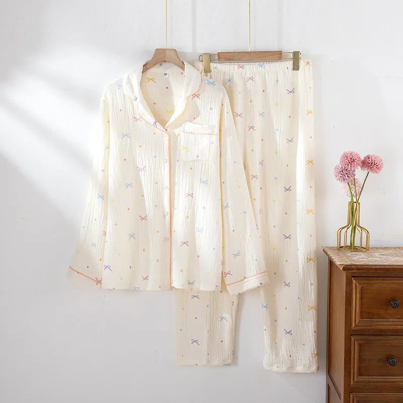 Women's thin cotton long-sleeve pajama set in beige, showing top and trousers laid flat.