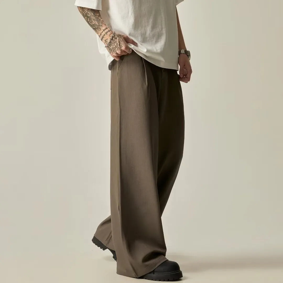 Men's solid colour casual trousers with wide-leg design and elasticated waist in cotton-polyester blend fabric