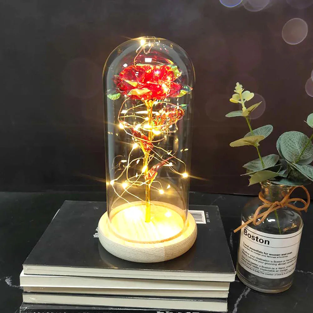 LED rose bouquet with glass lampshade showing warm white lights on simulation silk flowers.
