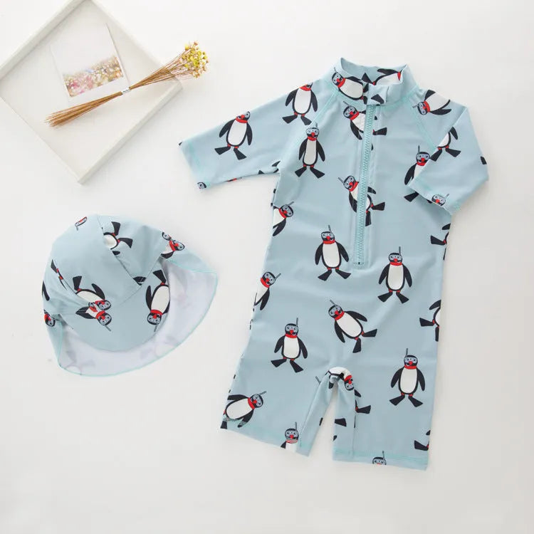 Boy's penguin print long sleeve swimsuit two-piece set with matching swim cap.