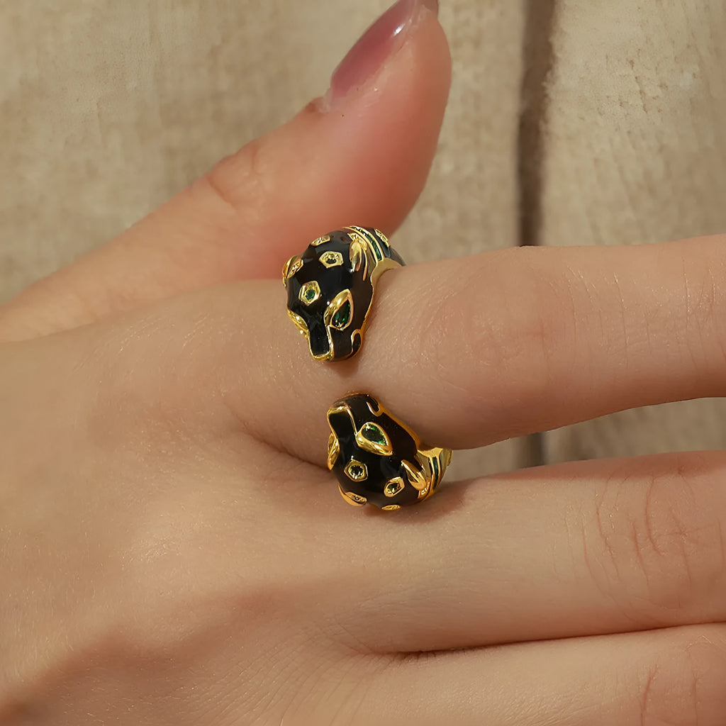 Geometric open fashion ring with a black cheetah print pattern, shown on a model's hand.
