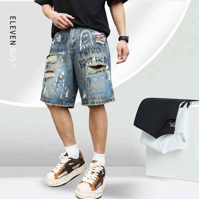 Blue denim shorts for men with ripped knees and graffiti design, featuring a straight leg and zipper fly.