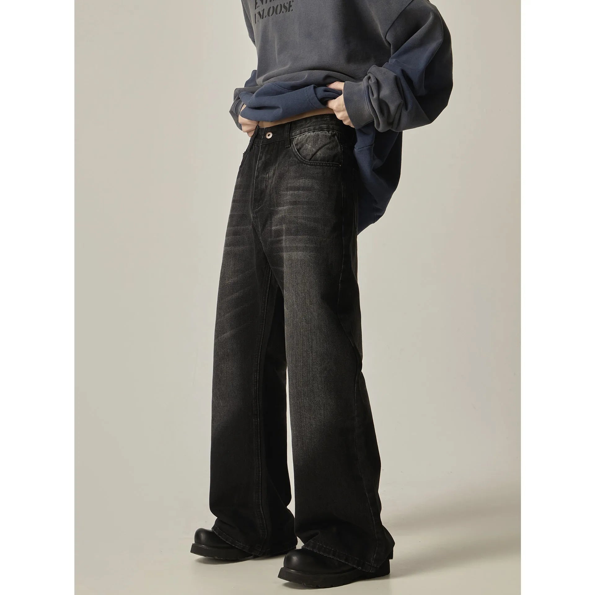 Man's black loose-fit straight-leg retro jeans made from polyester denim fabric.