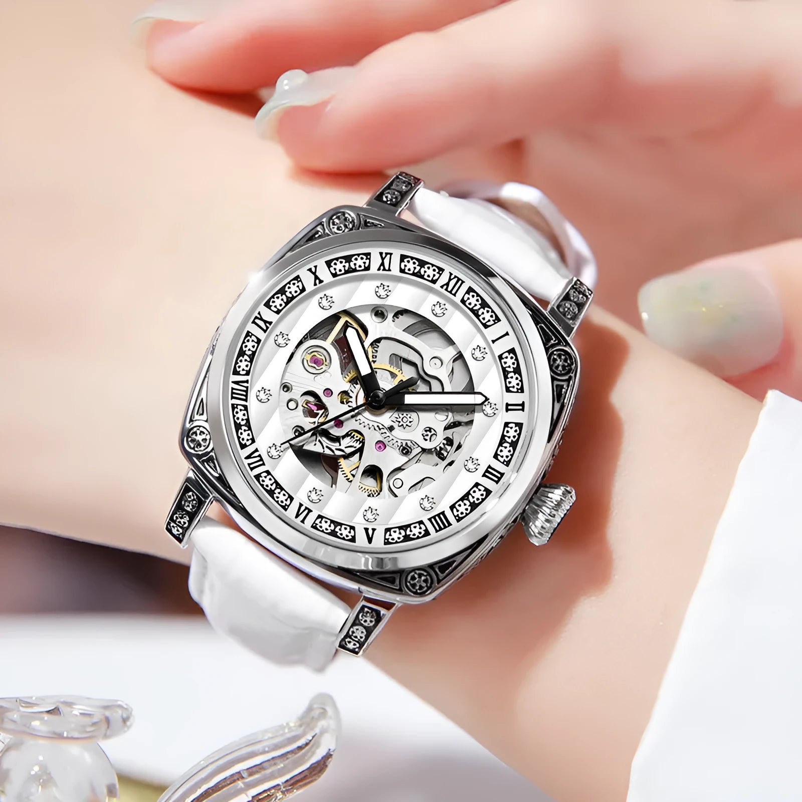 Mechanical analogue watch with luminous hands and a leather strap, shown in multiple colour options.