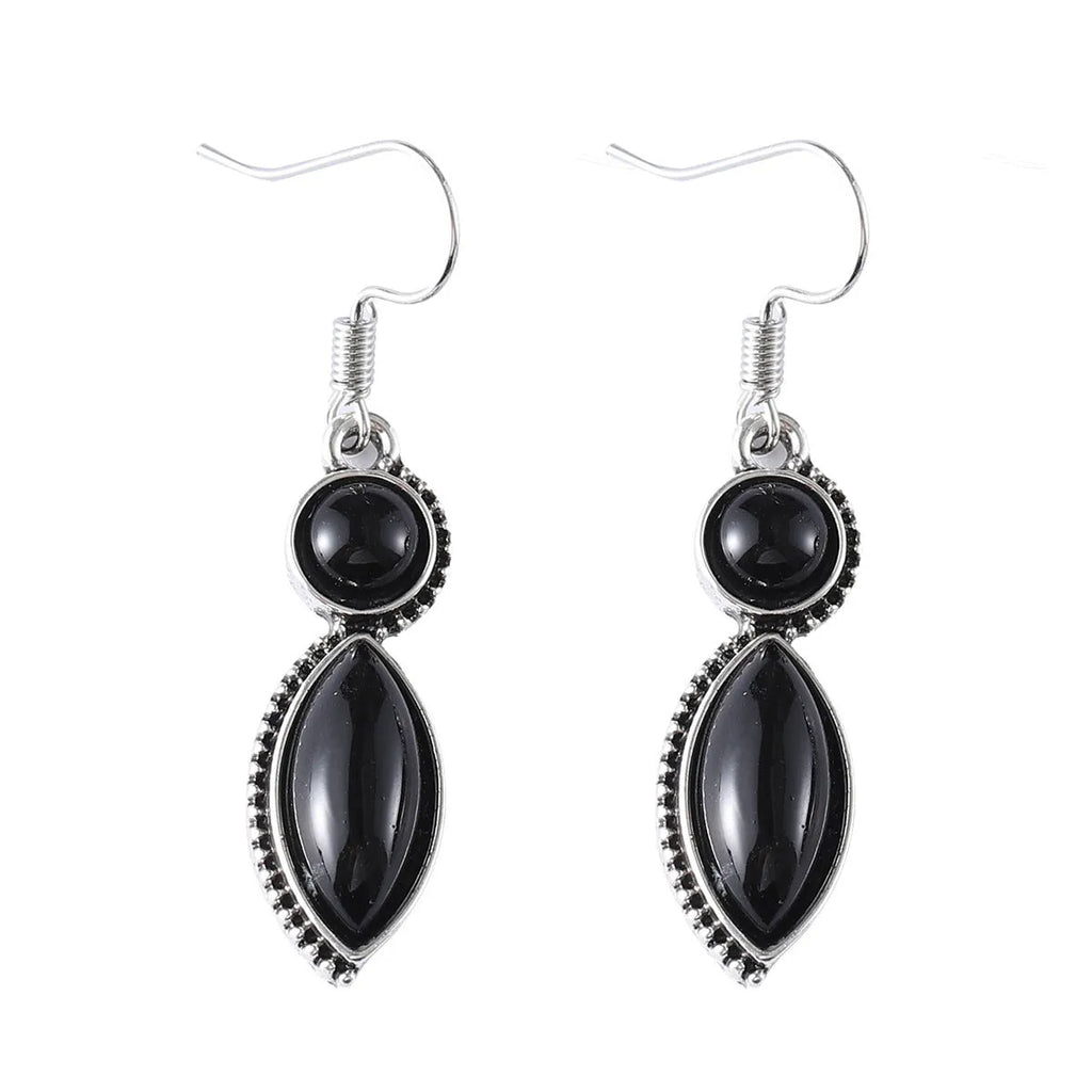 A pair of vintage-style geometric drop earrings with black and purple electroplated pendants on a white background.