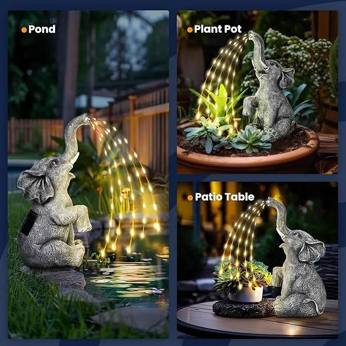 A textured resin elephant garden statue with a built-in LED light strip illuminating its back, placed amongst plants.