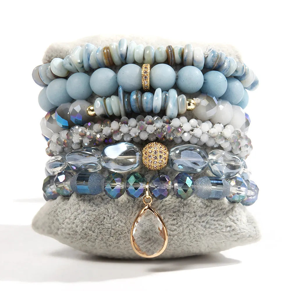 Women's glass beaded stretch bracelet set in brown with natural stone and zircon beads on a white surface