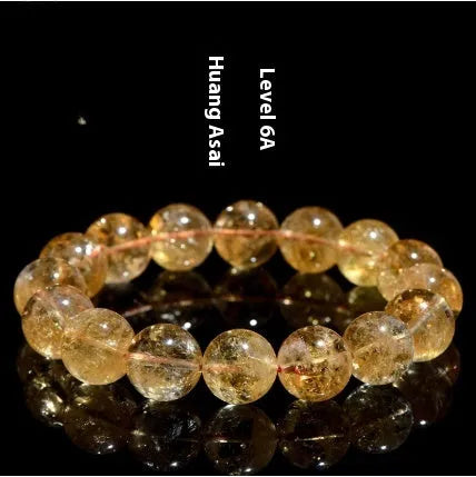 Natural yellow citrine Asestelle bracelet with geometric beads on a wrist.