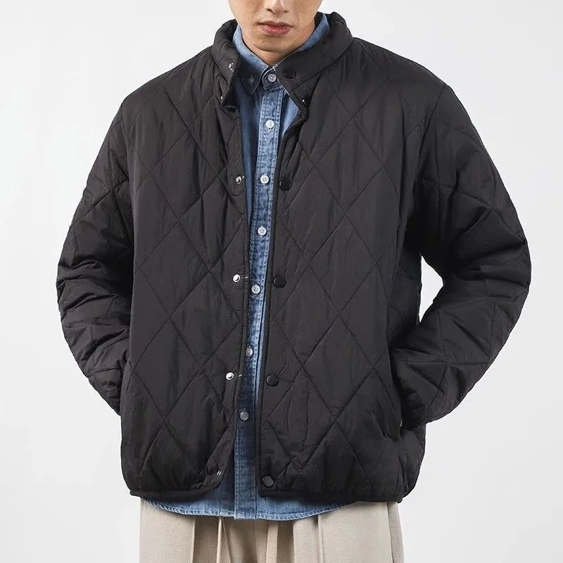 Men's black diamond lattice winter padded jacket showing extended length and loose fit