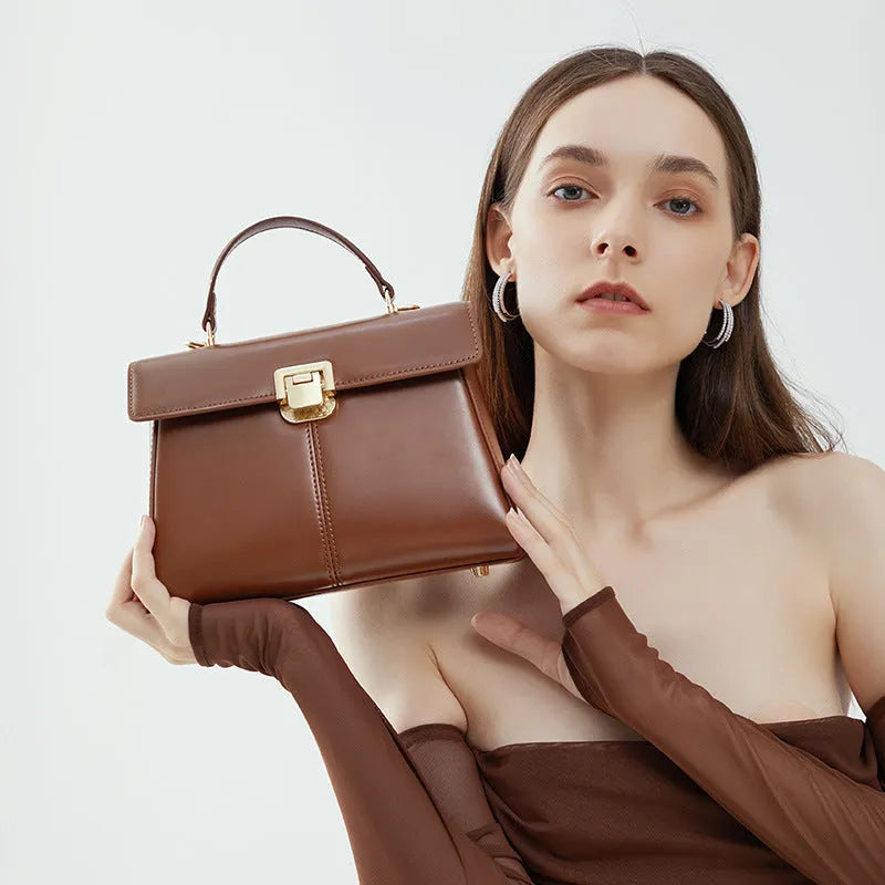 Dark brown women's genuine leather shoulder bag with a metal Vachette clasp, shown open to reveal an interior zippered pocket.