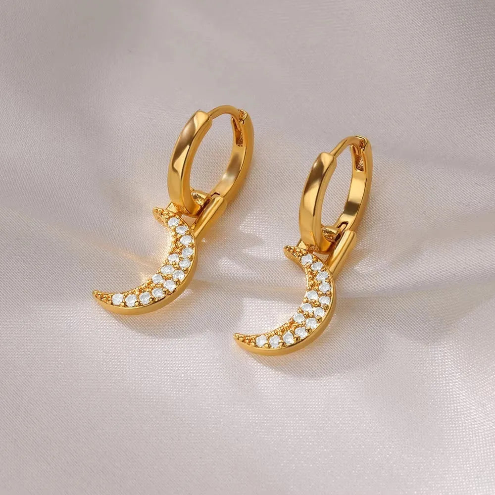 Women's geometric butterfly-shaped copper earrings with heart and star details in various colours.