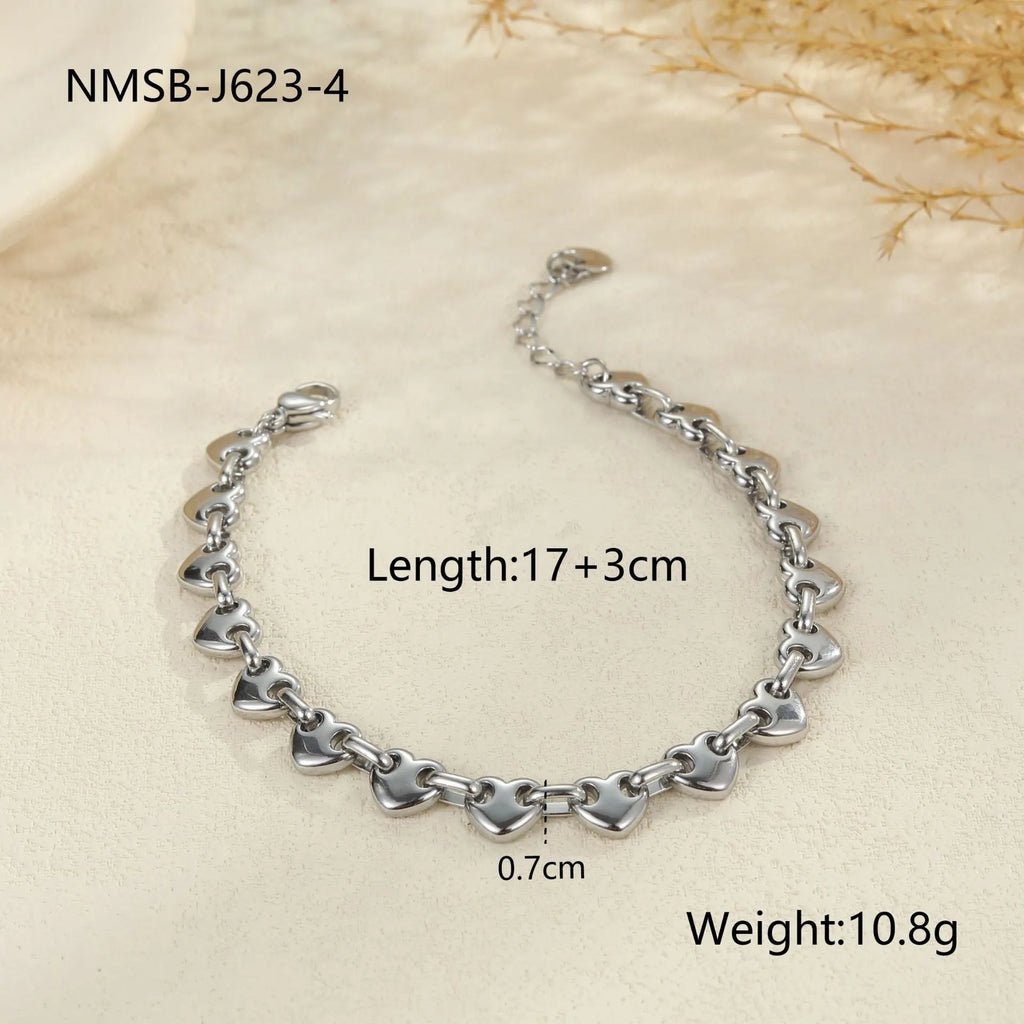 18K stainless steel hollow heart bracelet for women in gold, steel, or colour-blocked finish.