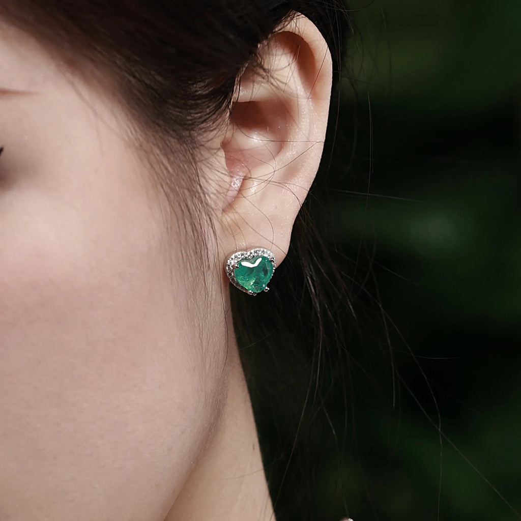 Green platinum 925 silver heart stud earrings on white background