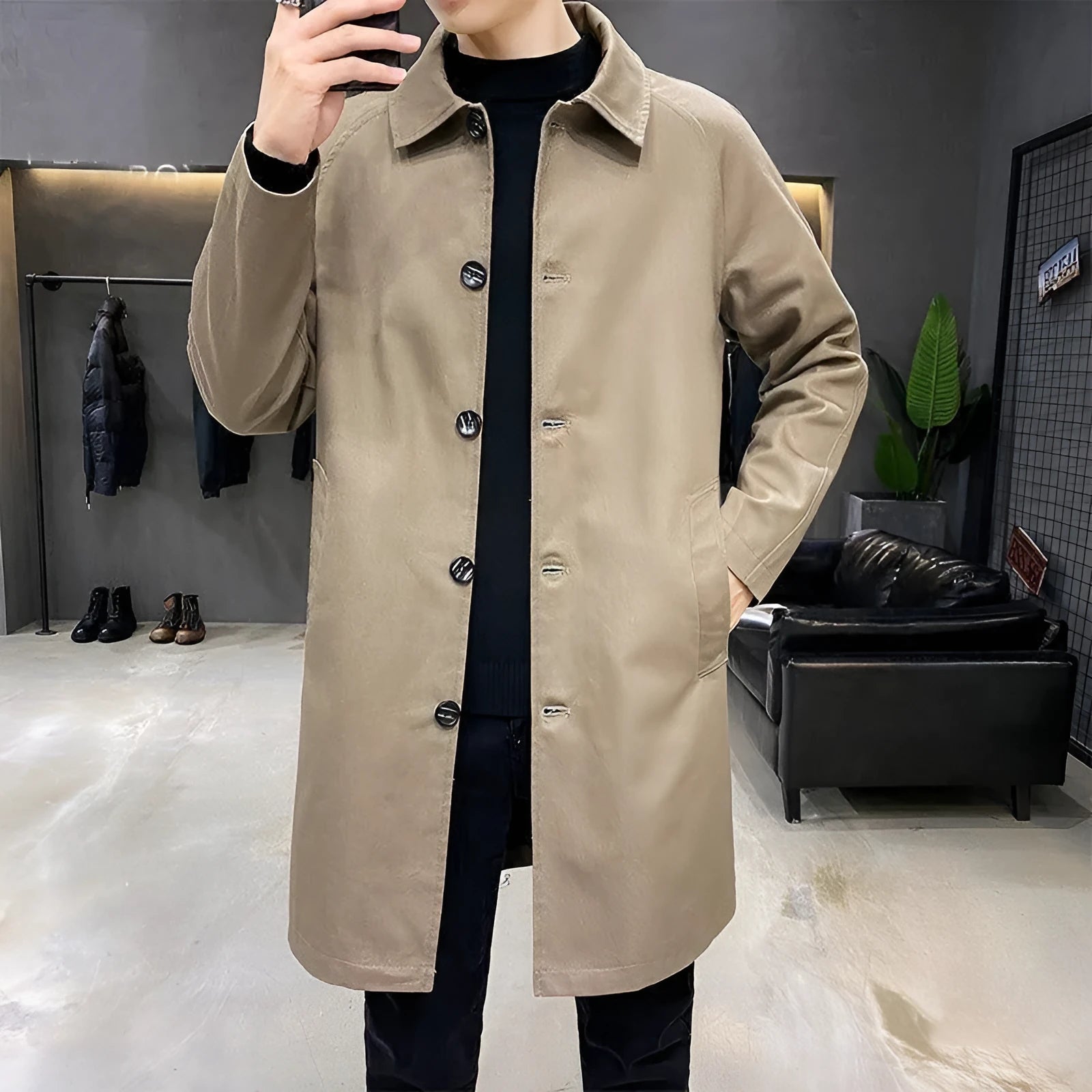 Man wearing a khaki-coloured, loose-fit mid-length trench coat made of rabbit fur.