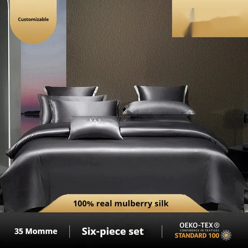 Silk four-piece bedding set in a solid colour displayed on a bed, showing quilt cover and pillowcases.