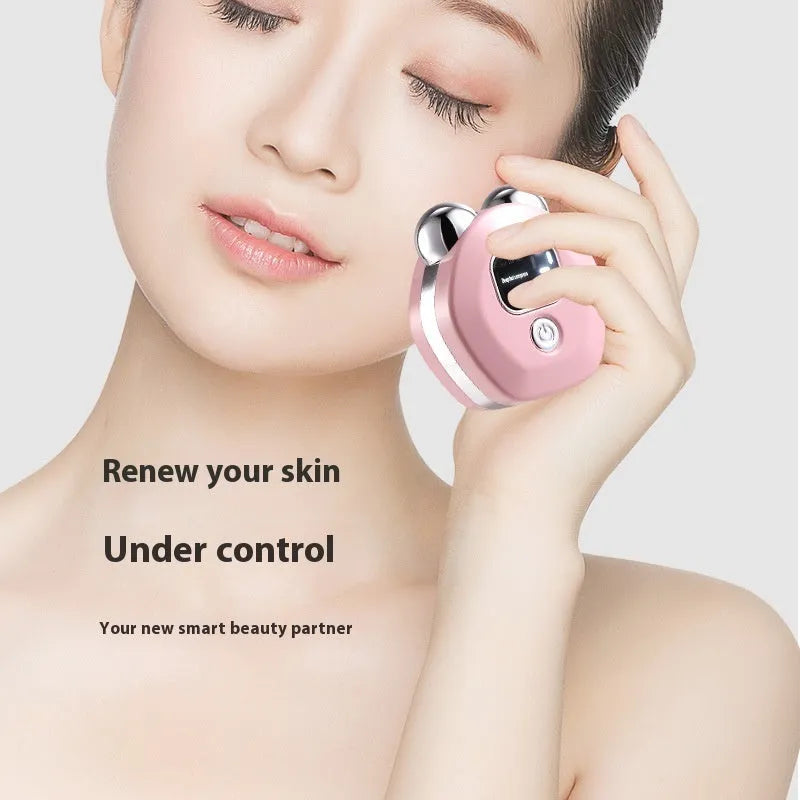 Portable white micro current facial massager with dual rollers and USB charging cable.