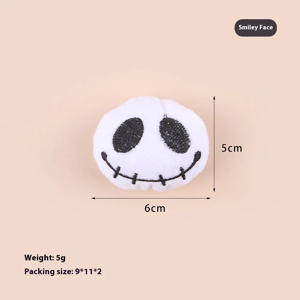 Small colourful plush cat teaser wand with candy, eyes, and skull designs