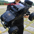 Large black 4WD off-road remote control car with 2.4G wireless controller on rough terrain