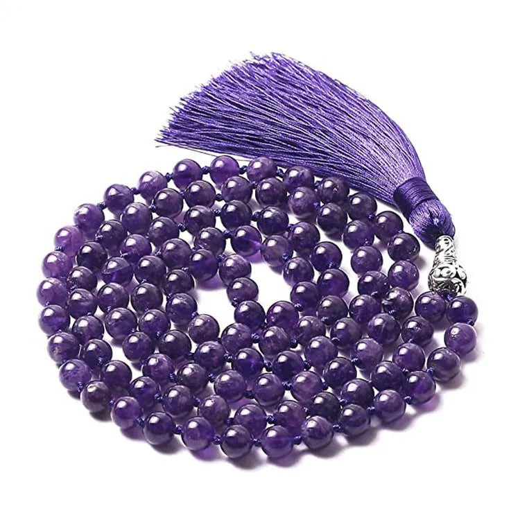 Long agate and amethyst gemstone tassel necklace with geometric pendant on a model.
