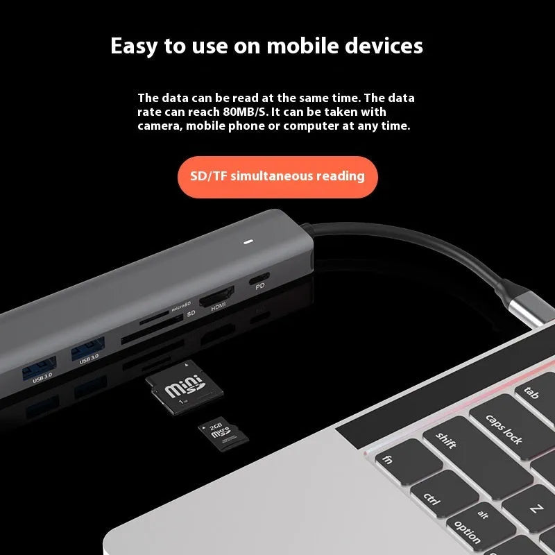 LQT-LH07 7-in-1 card reader and USB-C PD computer hub on a desk next to a laptop.