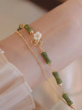 Handmade natural olivine bracelet with Chinese double layer design and olive branch motif.