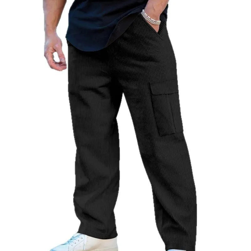 Men's straight-leg corduroy trousers in navy blue, showing loose fit and drawstring waist detail.