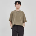 Men's brown loose drape knit casual T-shirt with short sleeves on a hanger.