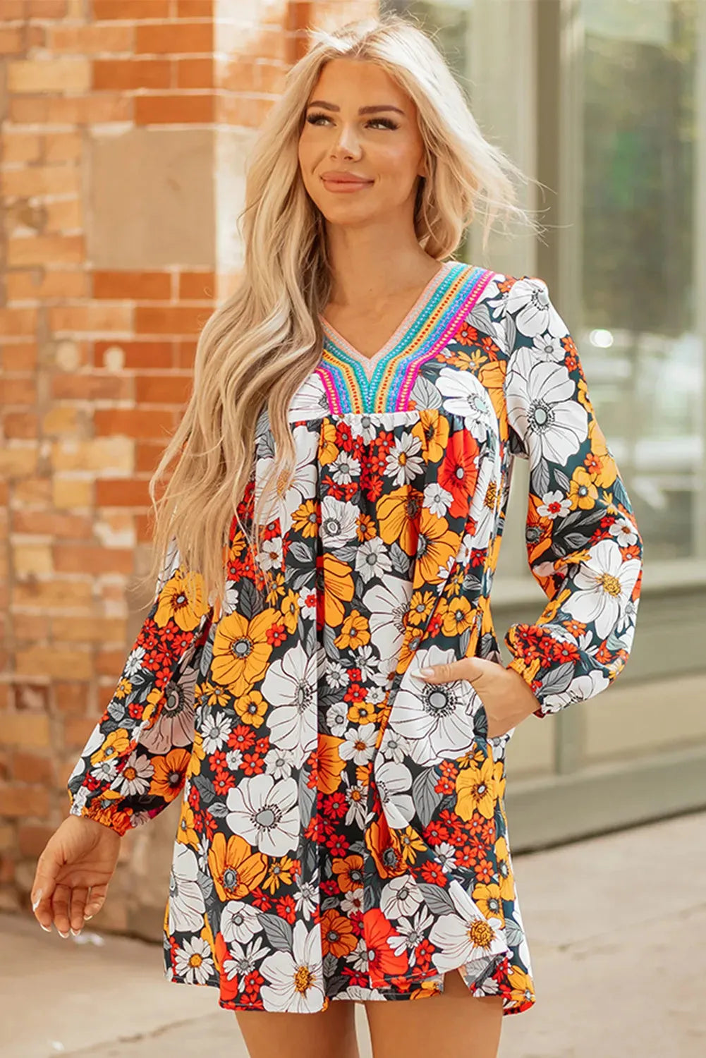 Orange striped floral print mini dress with long sleeves, V-neck, and lace detailing.