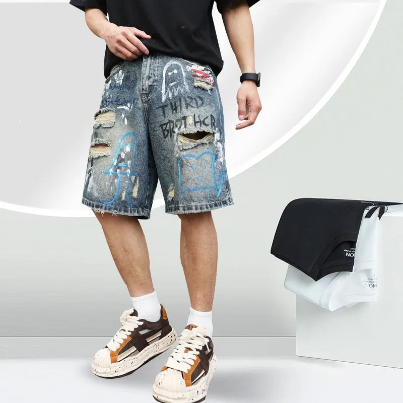 Blue denim shorts for men with ripped knees and graffiti design, featuring a straight leg and zipper fly.