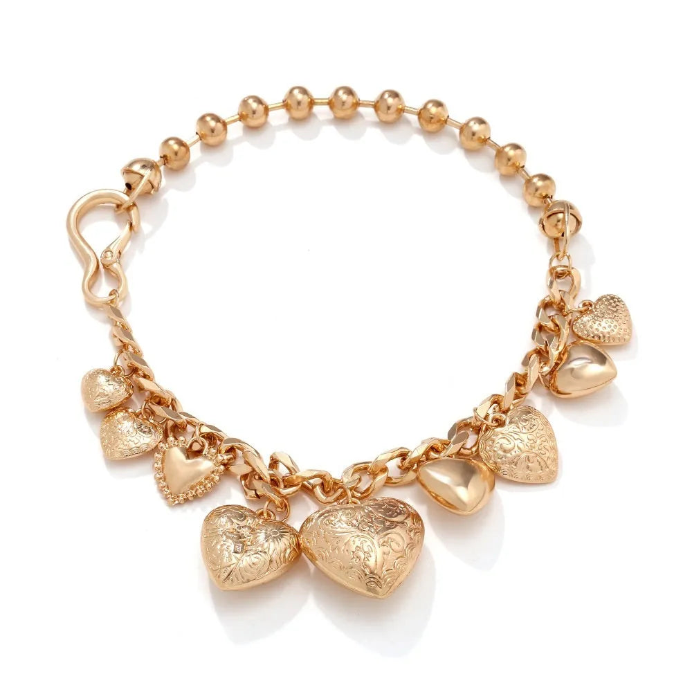 Gold carved heart-shaped pendant necklace on an adjustable metal chain.