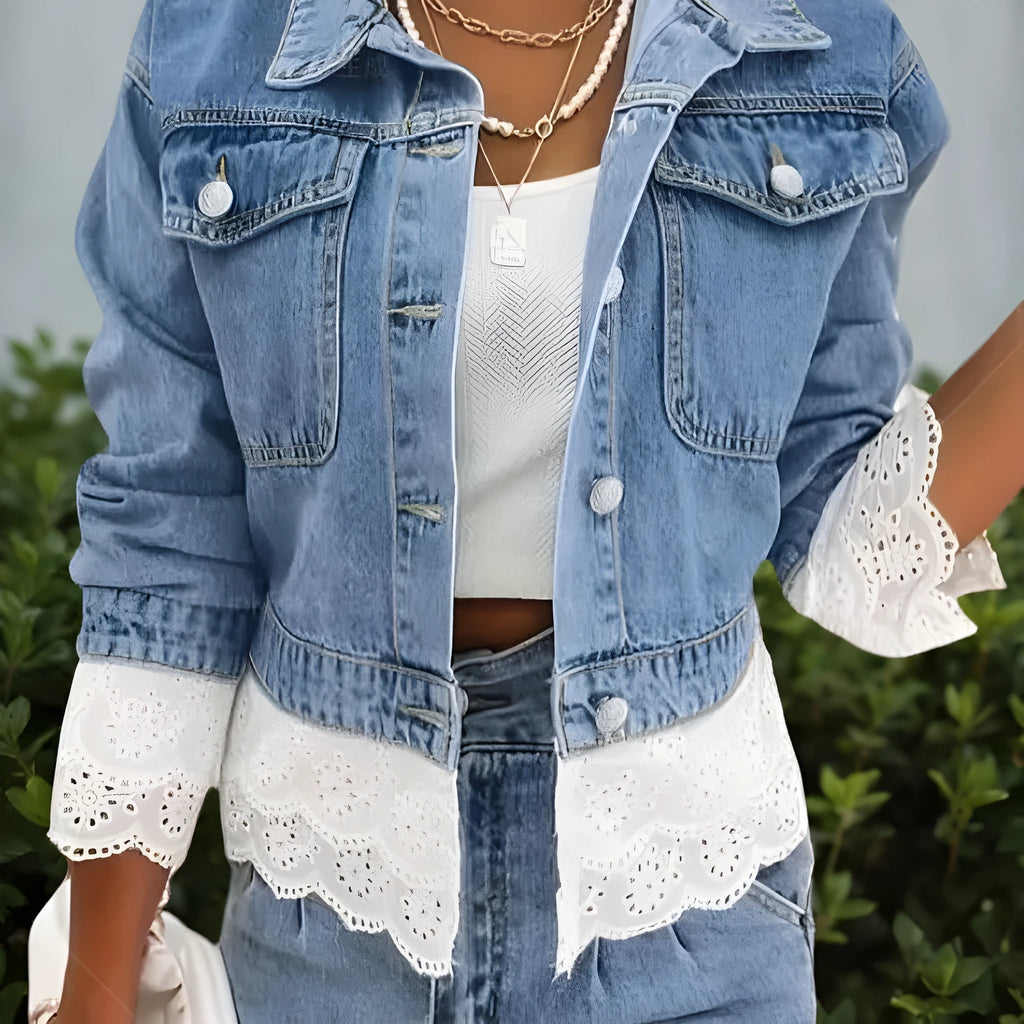 Blue women's denim jacket with lace stitching detail, shown on a hanger.