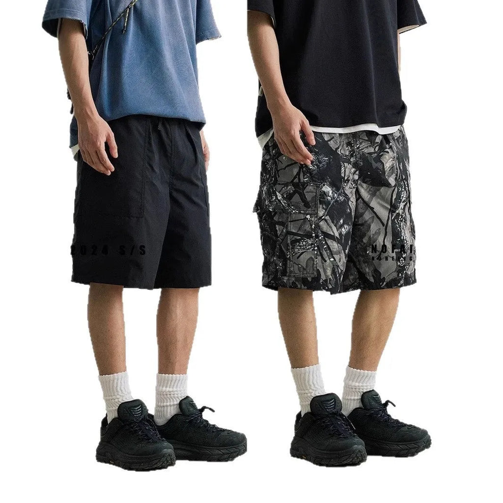 Loose casual straight-leg denim shorts in black on a hanger, showing mid waist and zip fly.