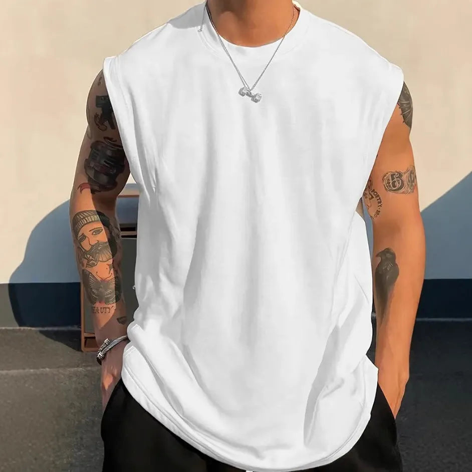 Men's loose sleeveless cotton t-shirt in a solid colour on a hanger.