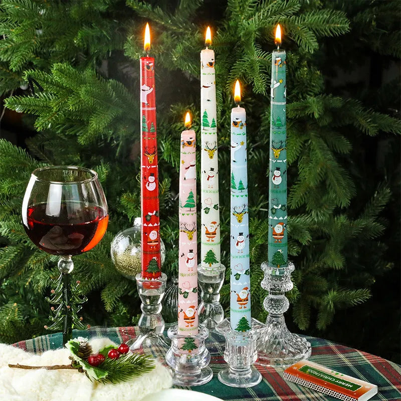Cylindrical Christmas printed paraffin candle in bright red, 2.2 x 25 cm, on a wooden table