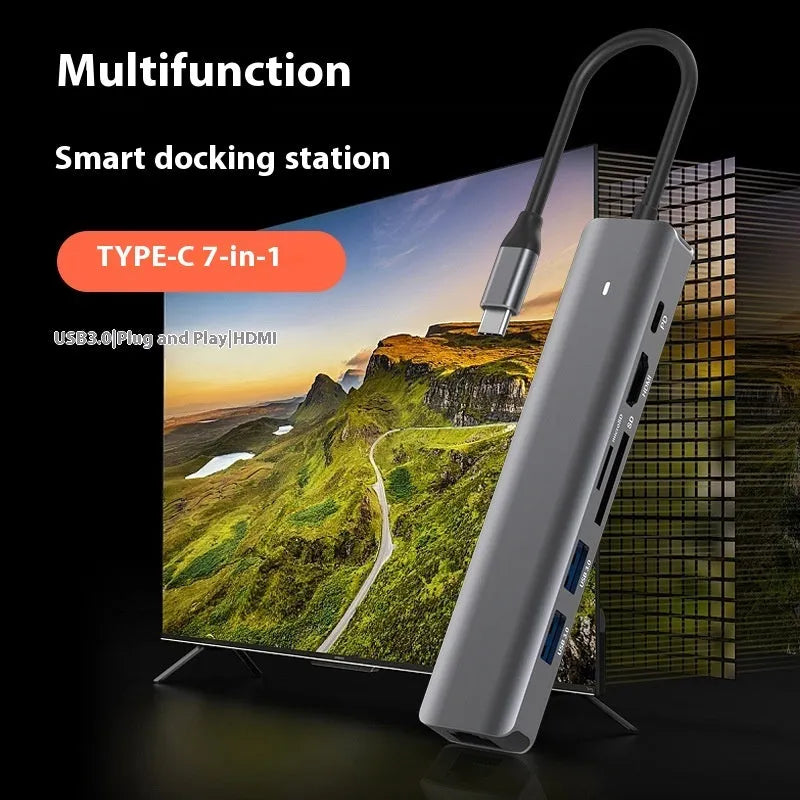 LQT-LH07 7-in-1 card reader and USB-C PD computer hub on a desk next to a laptop.