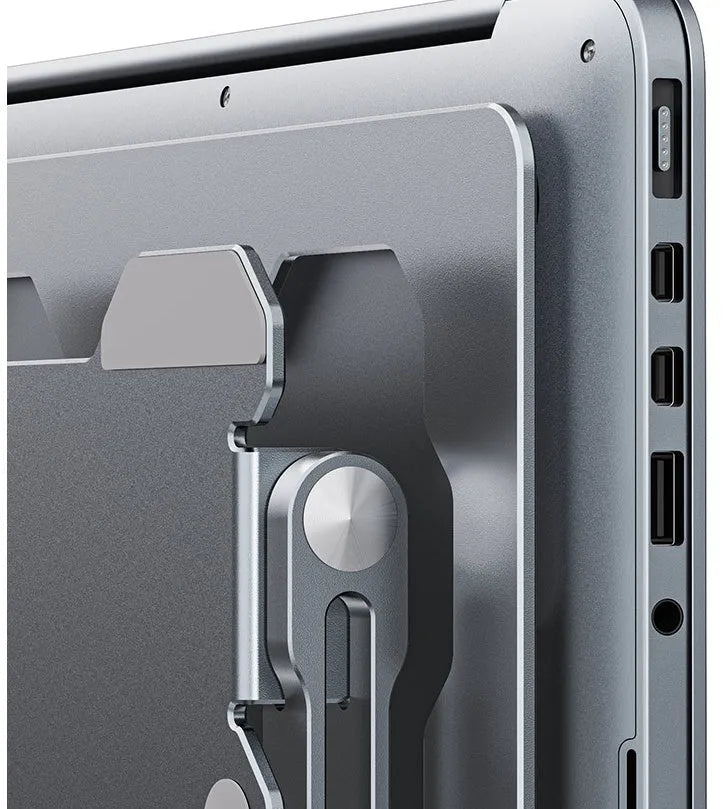 Grey aluminium adjustable laptop stand holding a silver laptop, showing its hollow design and folded position.