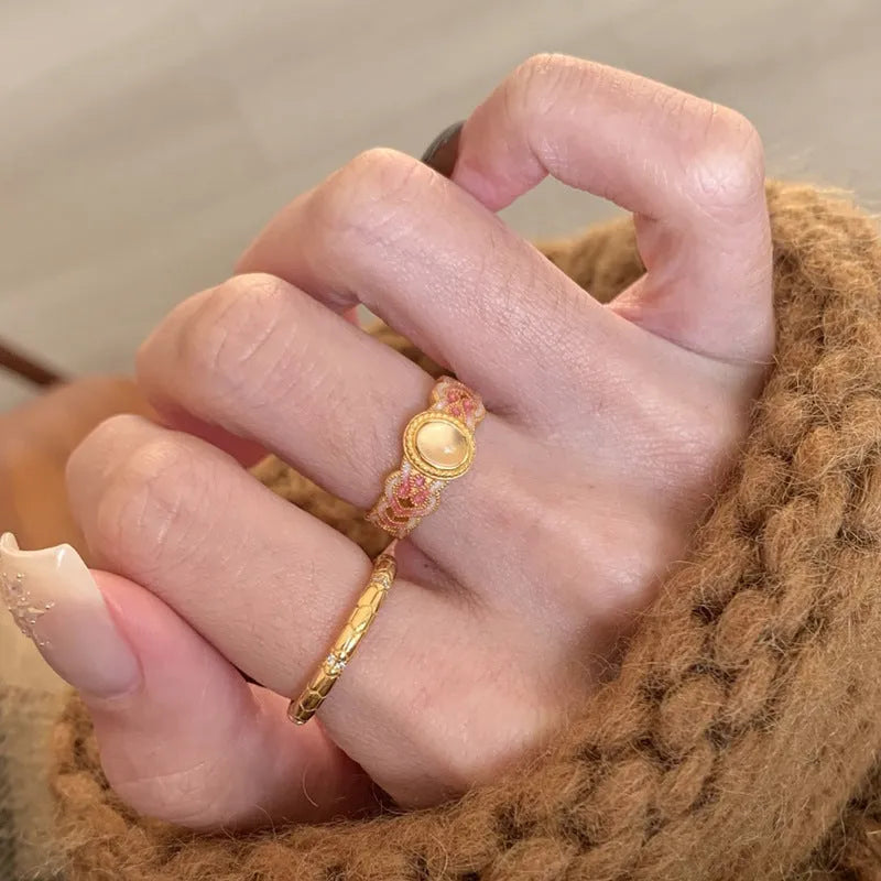 Geometric open ring with pink crystal enamel on gold-plated copper band.
