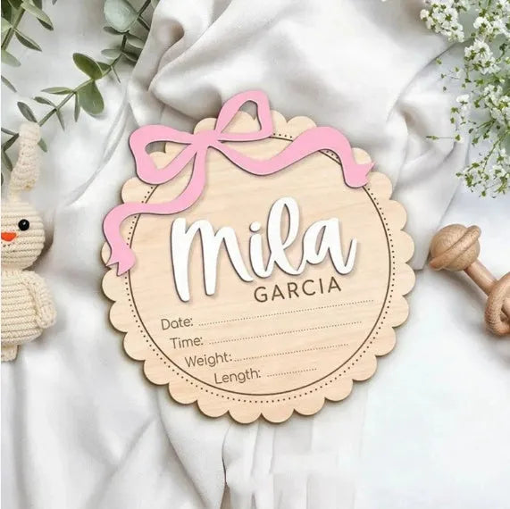 Square wooden baby room ornament with a customised name, shown in two size options.