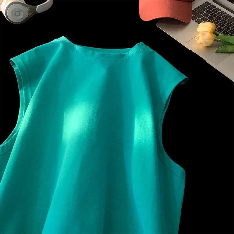 Men's loose fit solid colour cotton tank top shown in a selection of available colours and sizes.
