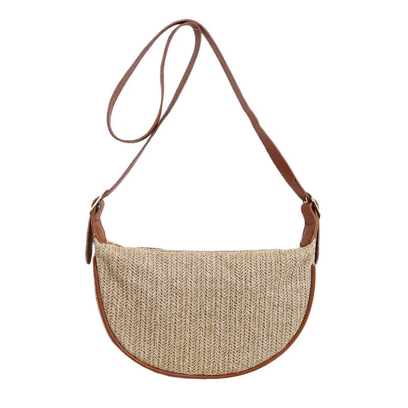 Women's straw woven crossbody bag showing knitted texture and single shoulder strap, shown in corrugated black colour.