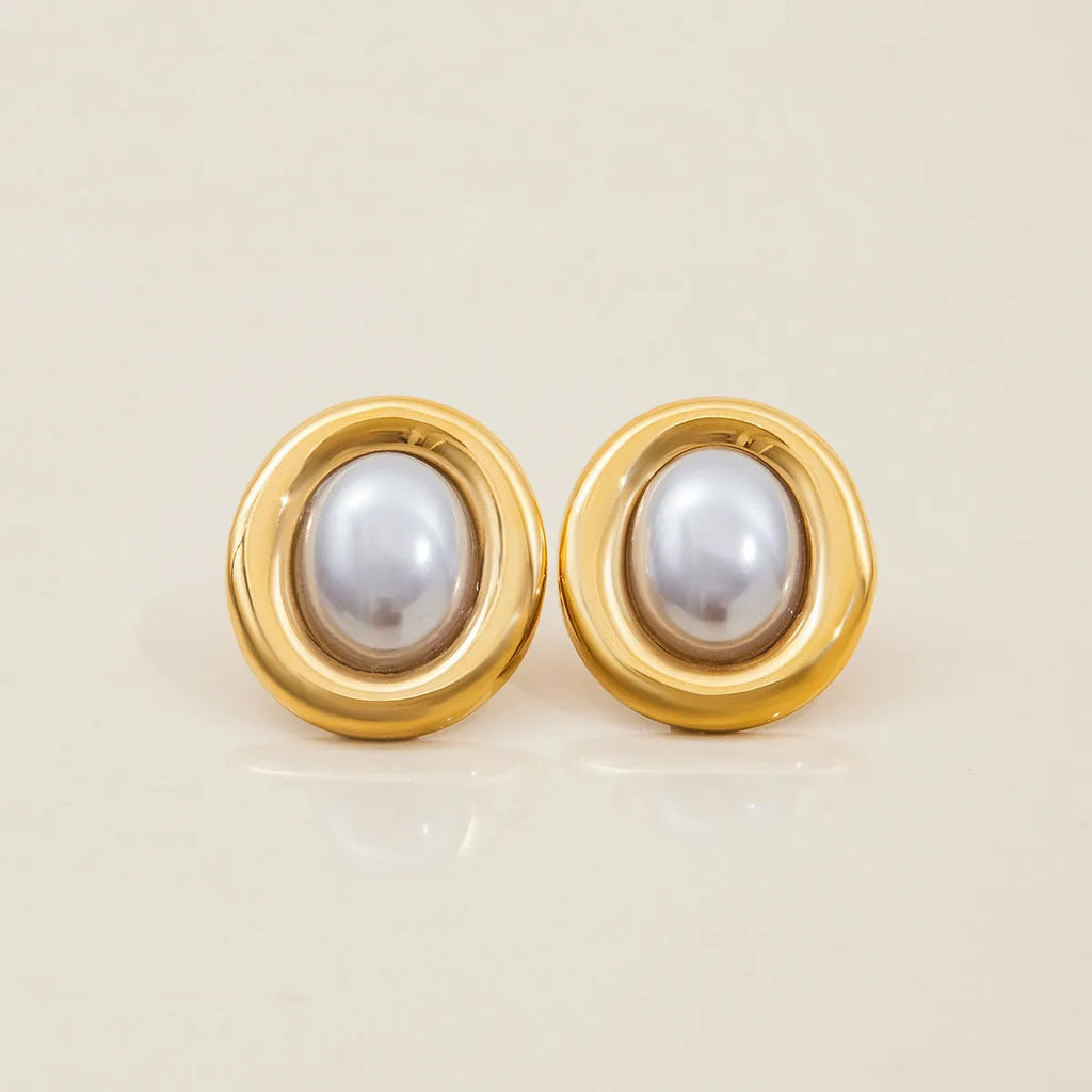 A pair of stainless steel vintage pearl stud earrings for women with a post-back closure.